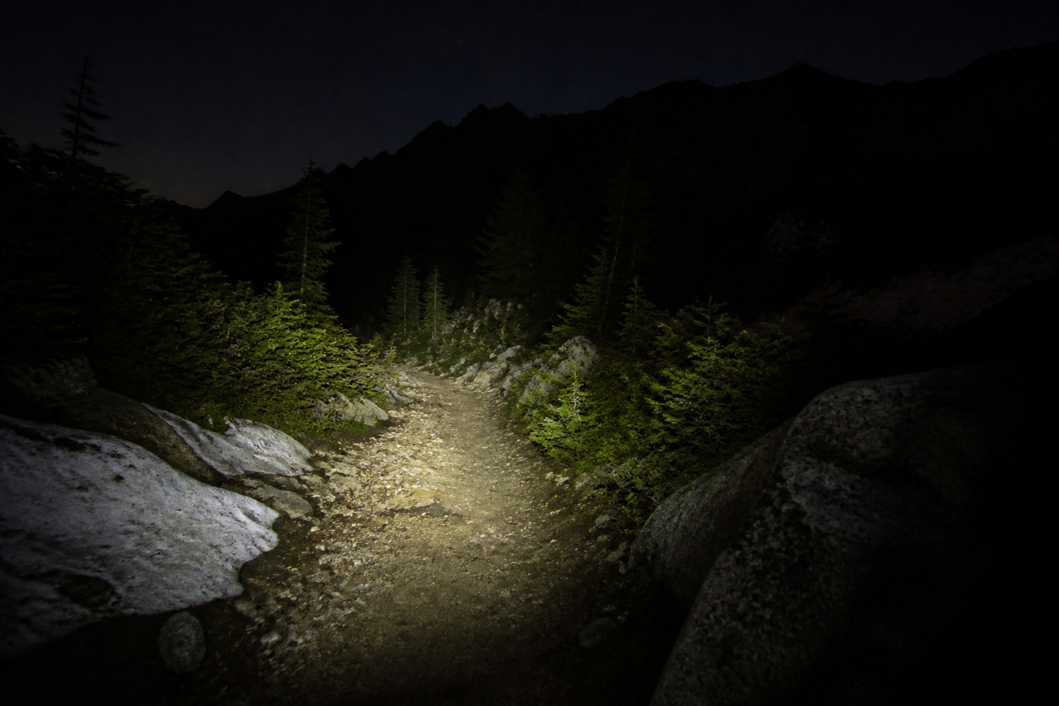 Headlamp on a dawn trail start