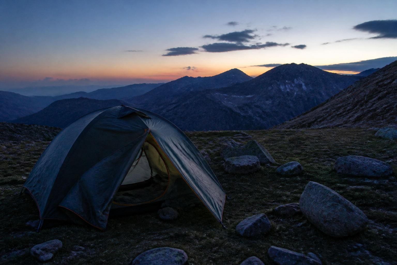 Alpine tent pitched at a mountain campsite
