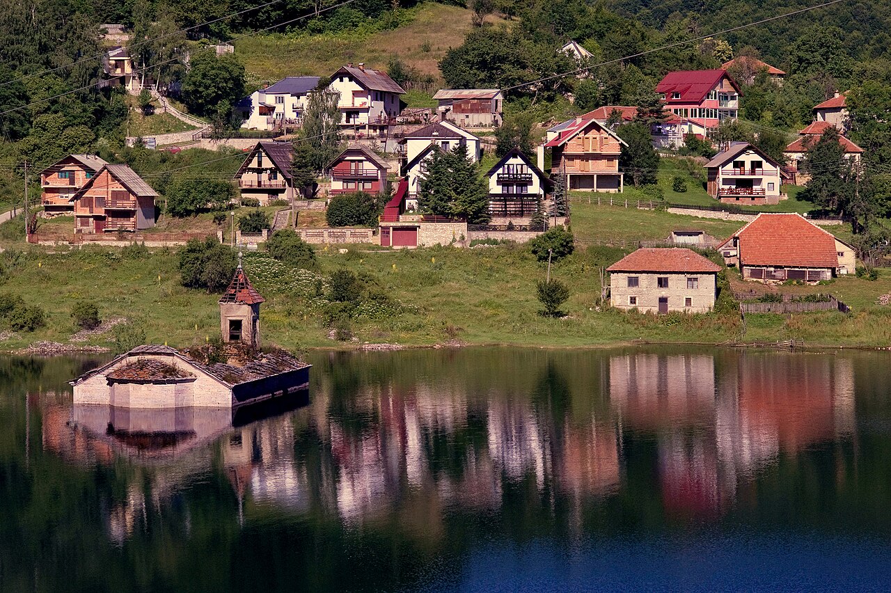 Church of St. Nicholas rising from Mavrovo Lake, North Macedonia
