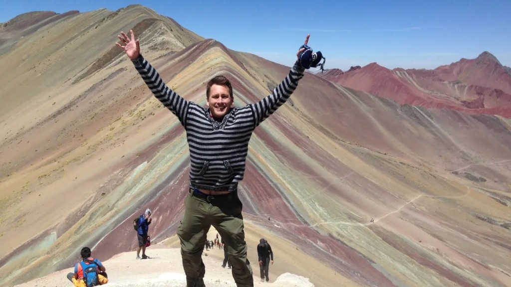 Lee celebrating at the summit of Vinicunca (Rainbow Mountain), Peru